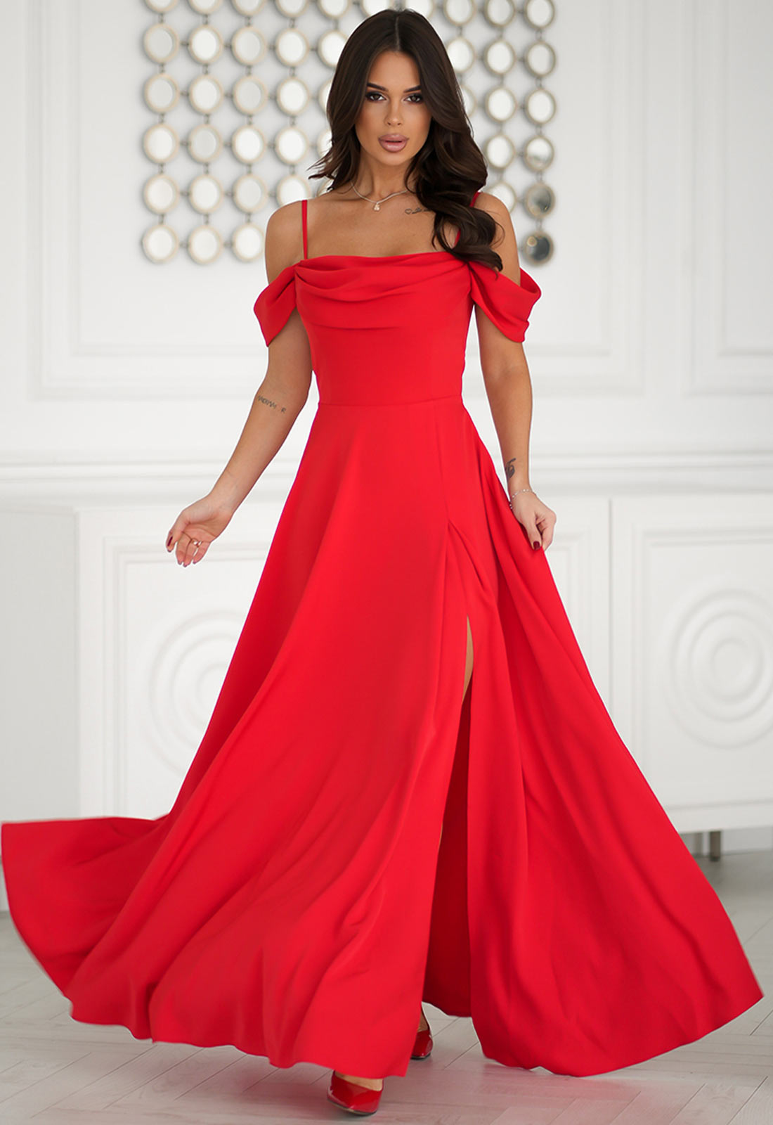 Woman wearing a red off-shoulder gown in an elegant indoor setting