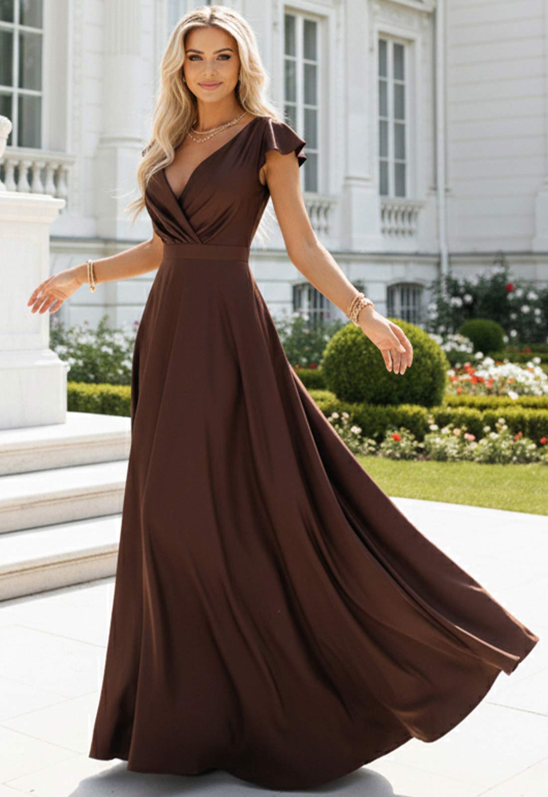 Woman in a brown evening gown standing in front of a classical building.