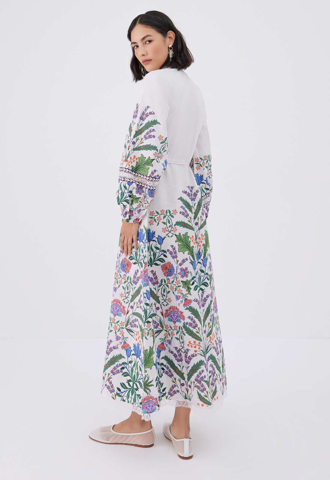 Woman wearing a floral dress on a white background