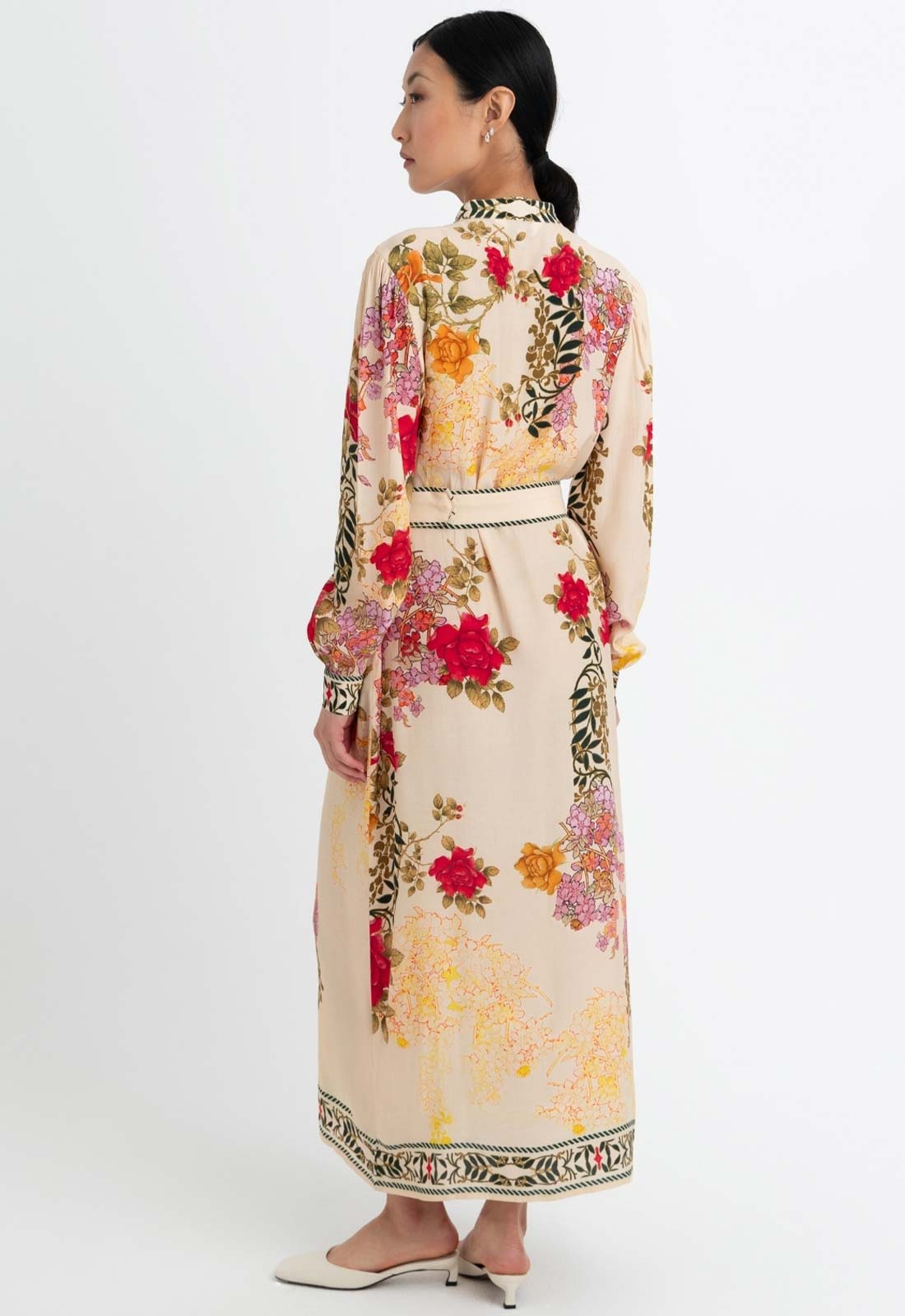 Woman wearing a floral dress with a white background