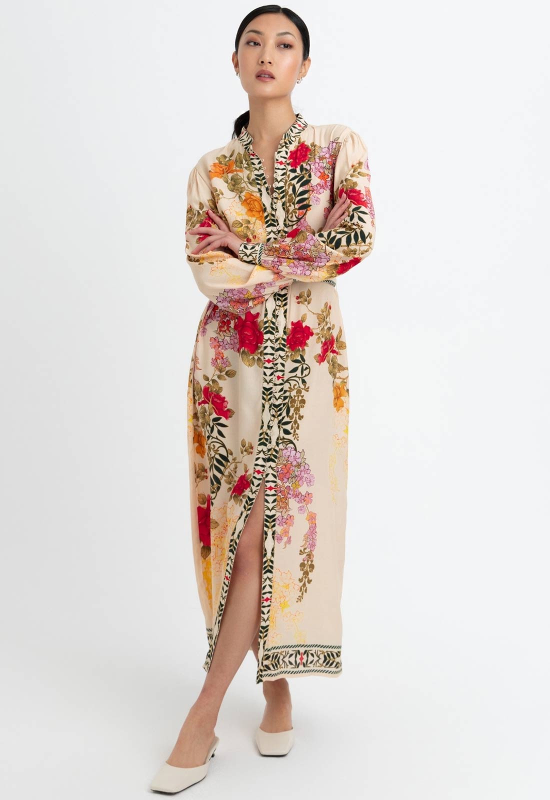 Woman wearing a floral and animal print dress on a white background