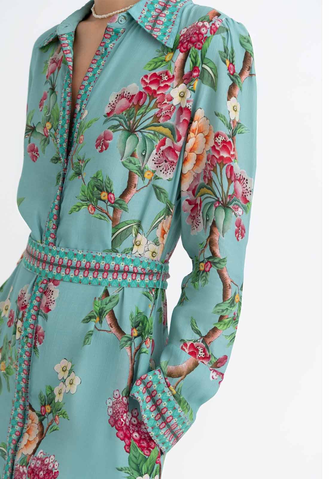 Teal dress with floral pattern on a white background