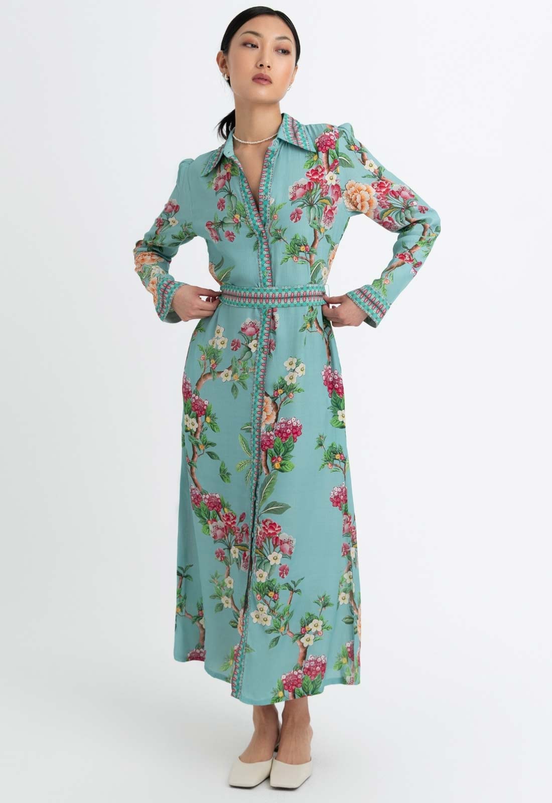Woman wearing a floral dress with a white background