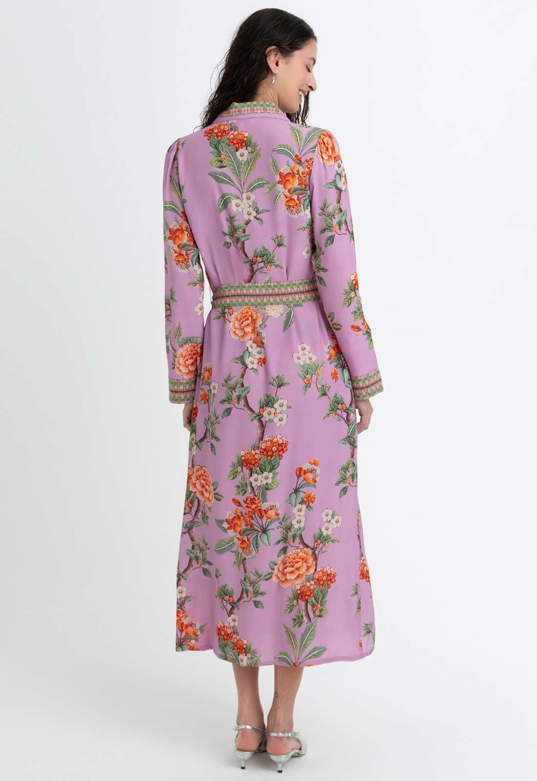 Woman wearing a floral dress with a purple background