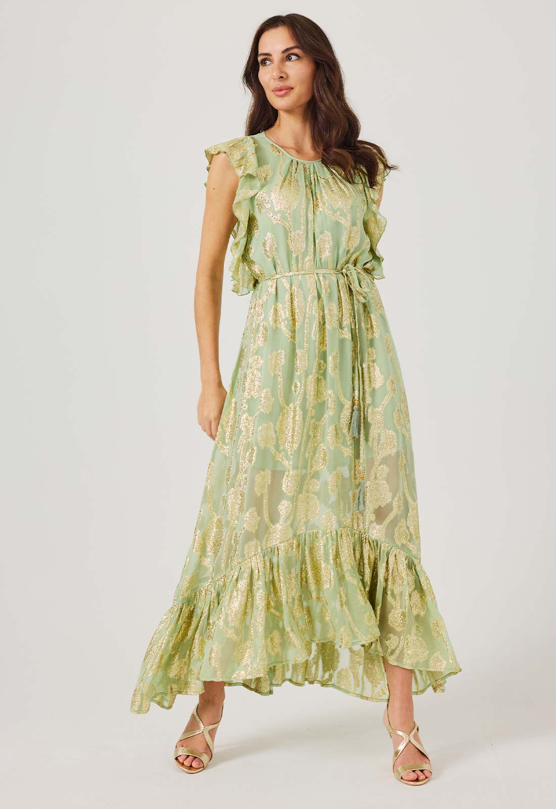 Woman wearing a green floral dress on a white background