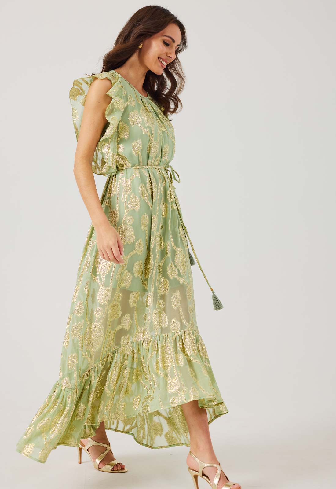 Woman wearing a green floral dress on a white background