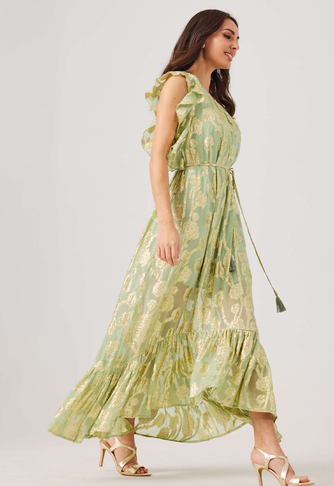 Woman wearing a green floral dress on a white background