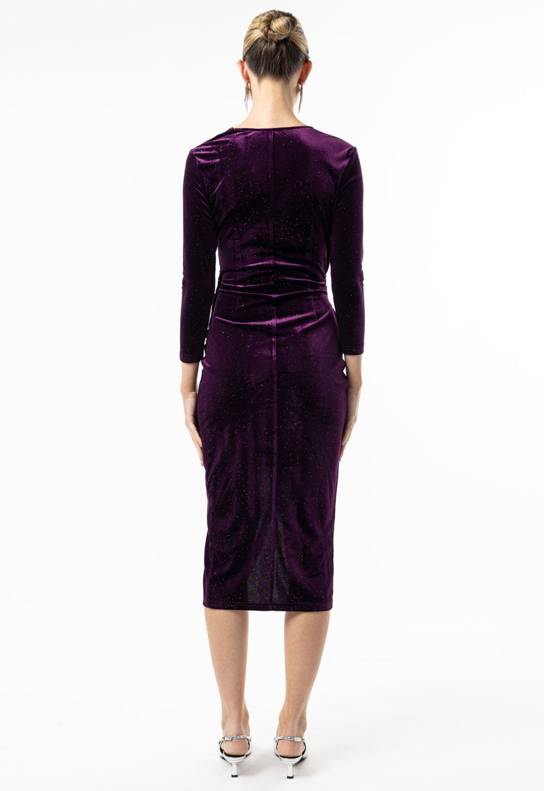 Purple velvet dress worn by a model on a white background