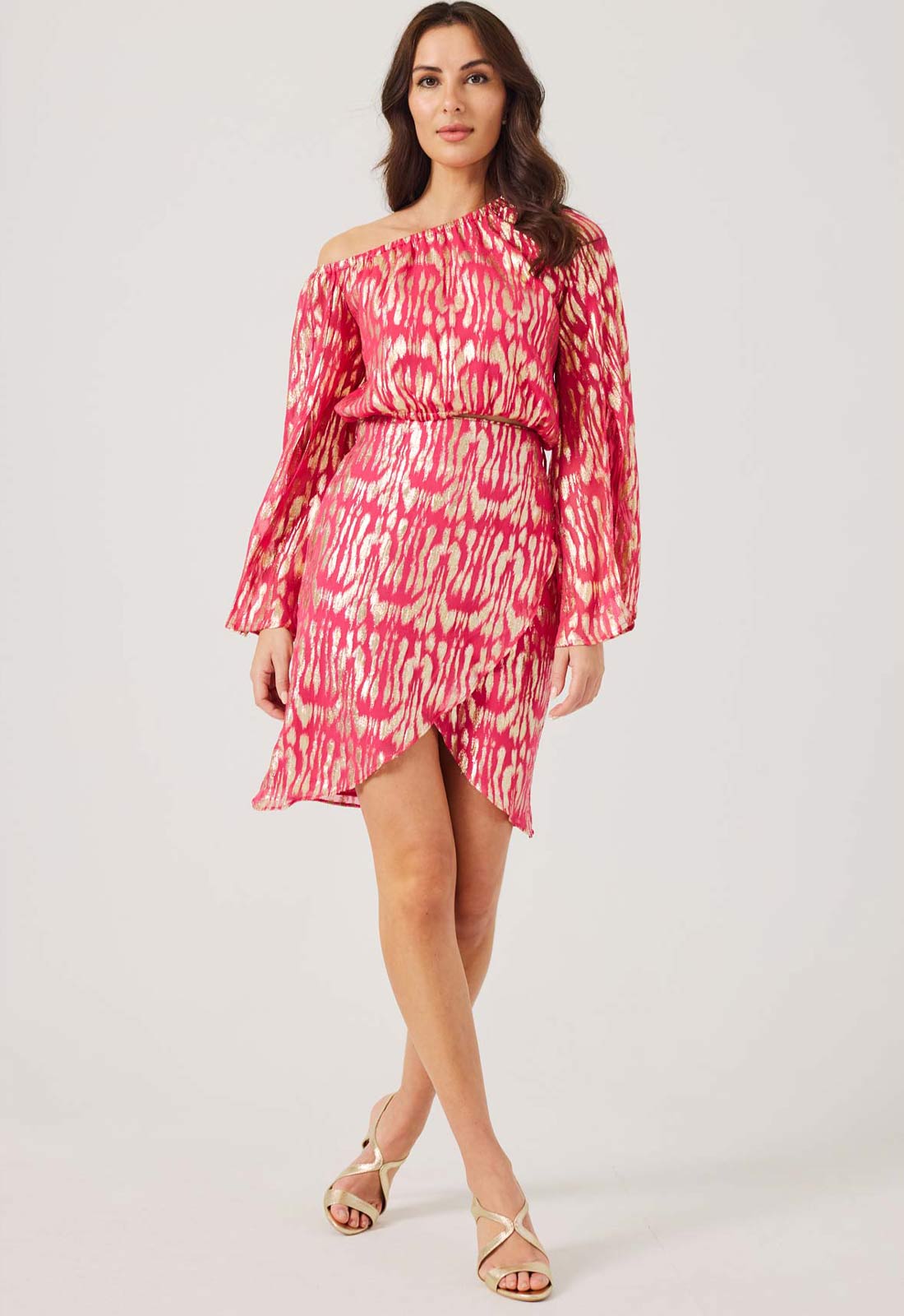 Woman wearing a pink and white patterned dress on a white background