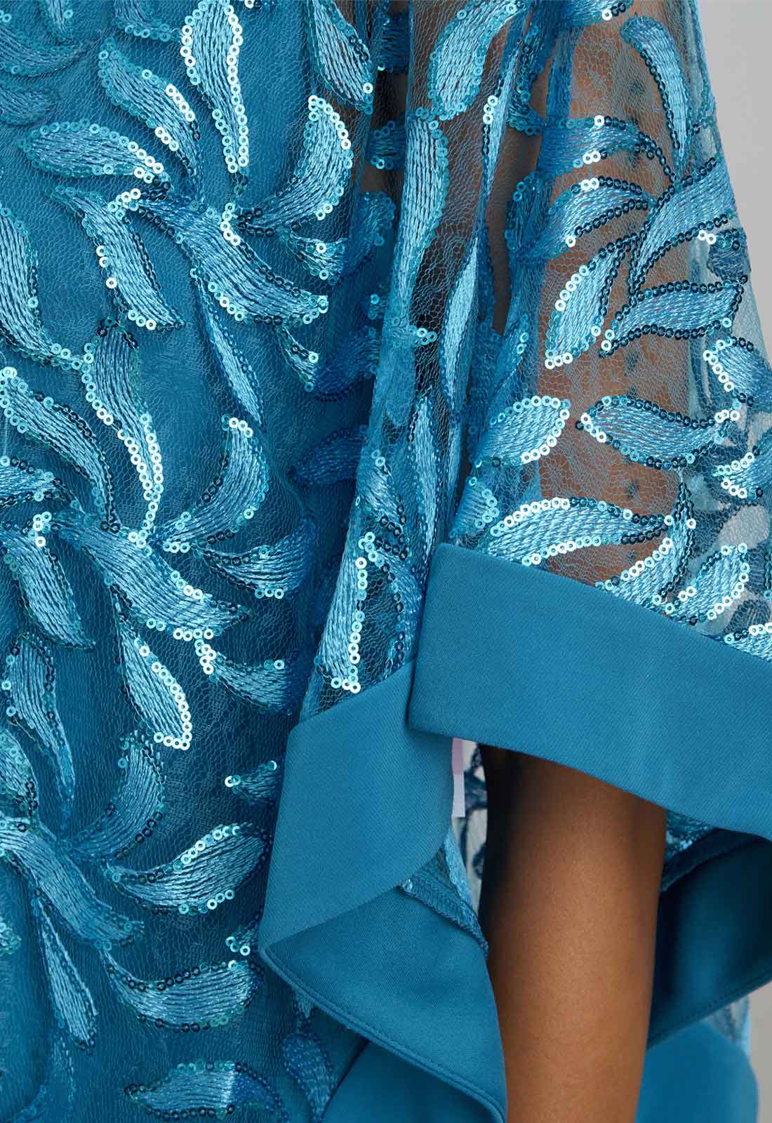 Close-up of a blue sequin dress with intricate patterns