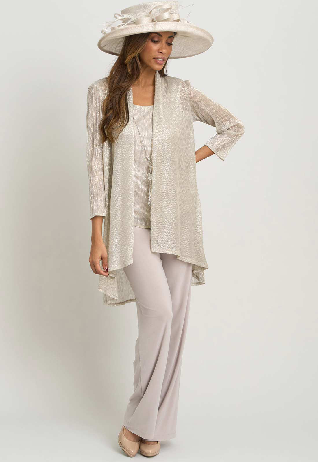 Woman wearing a light gray outfit with a matching hat on a white background