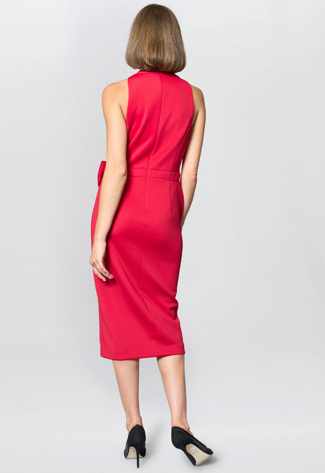 Woman wearing a red dress on a light gray background