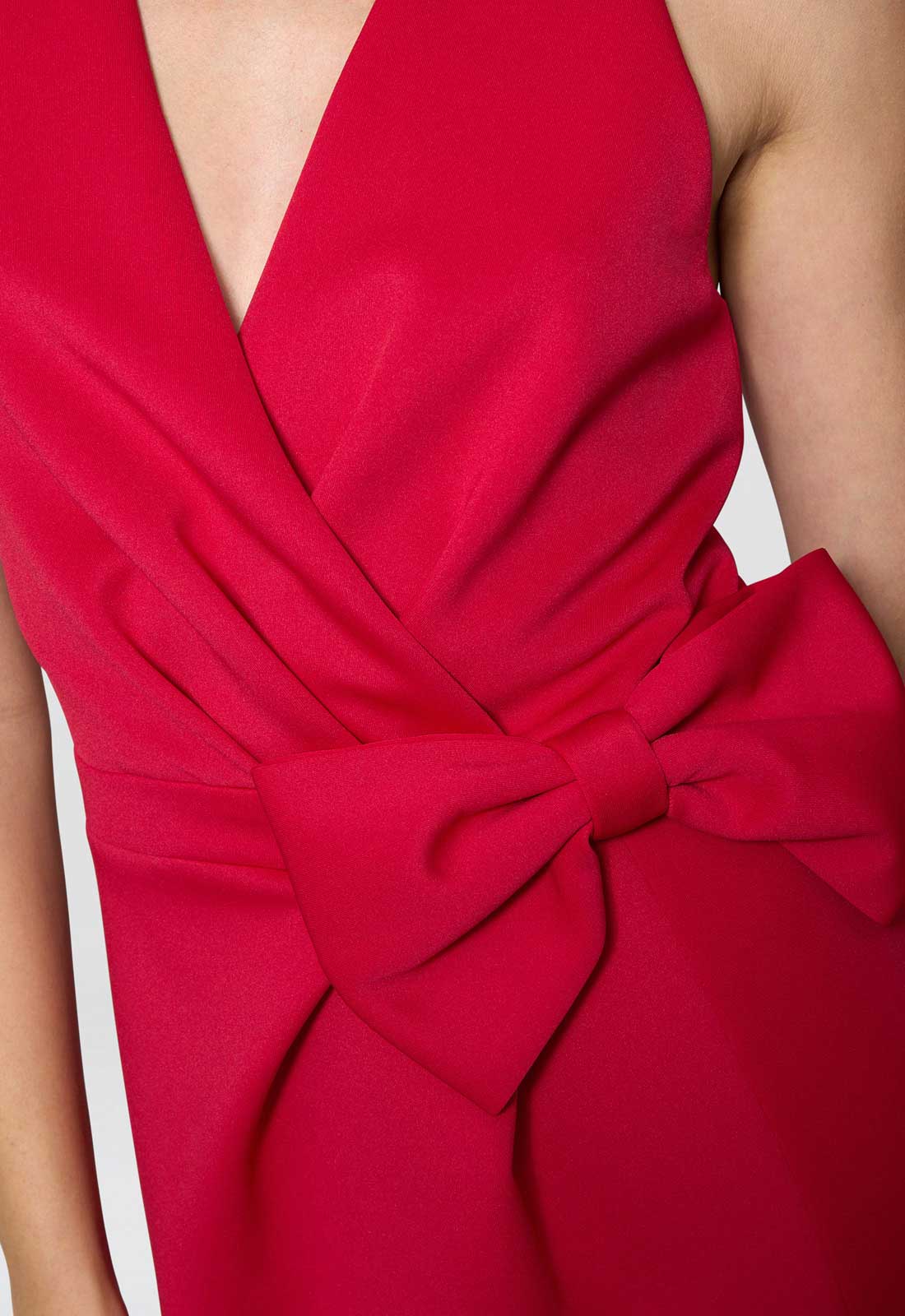 Red dress with a large bow detail on a white background