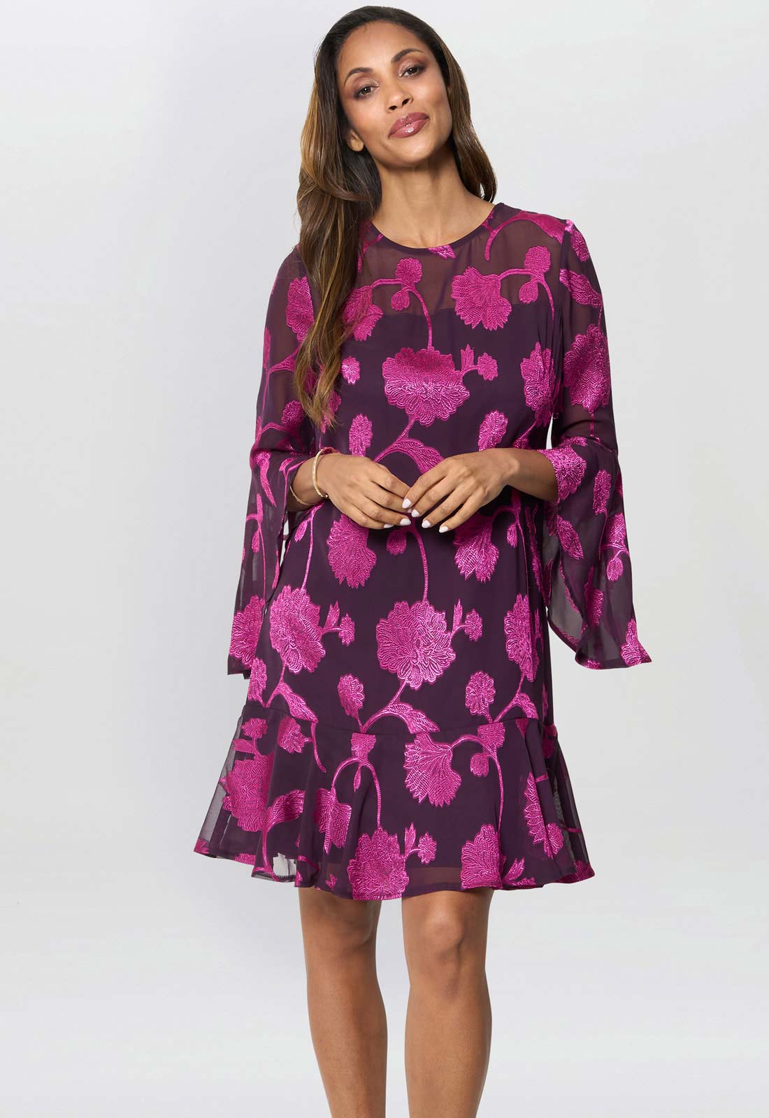 Woman wearing a purple floral dress on a white background