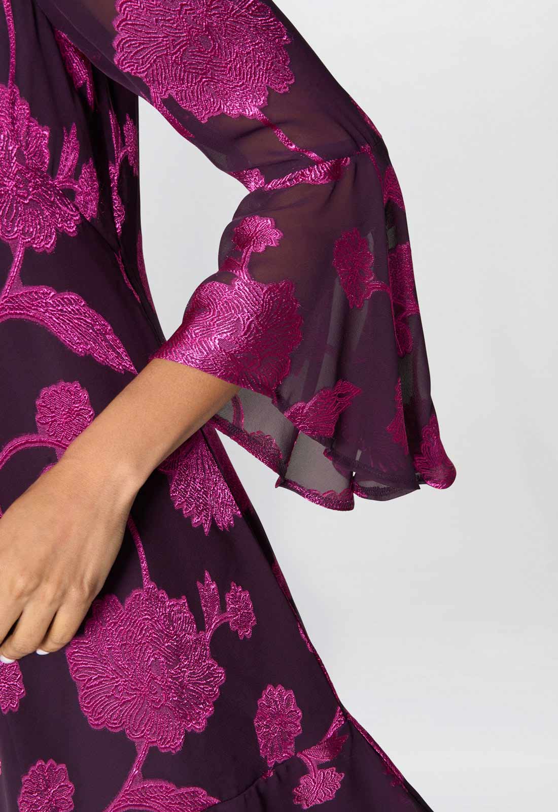 Purple dress with pink floral patterns on a white background