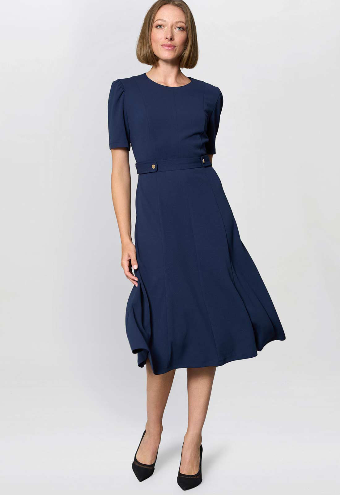Woman wearing a navy blue dress on a white background