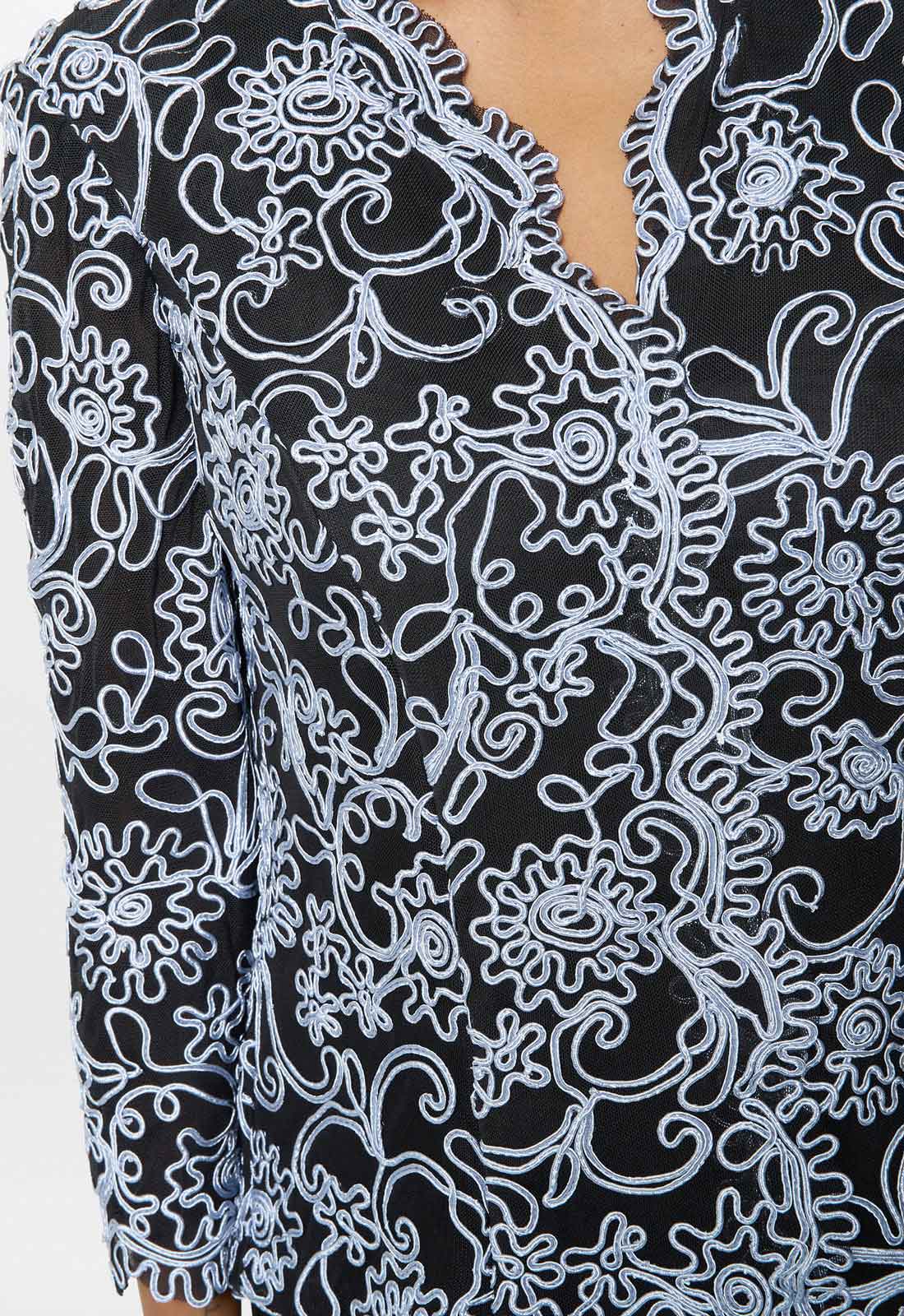 Close-up of a black and white patterned garment with a deep neckline.