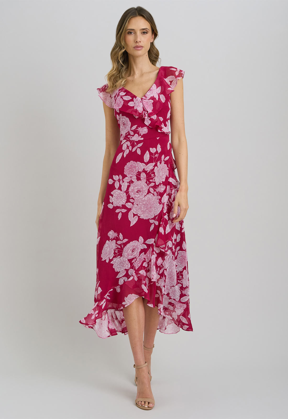 Woman wearing a pink floral dress on a white background