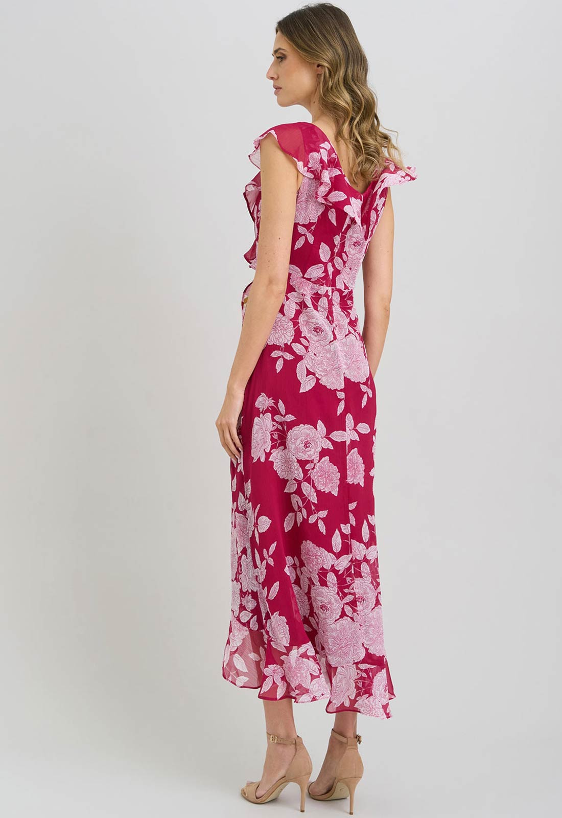 Woman wearing a pink floral dress on a white background