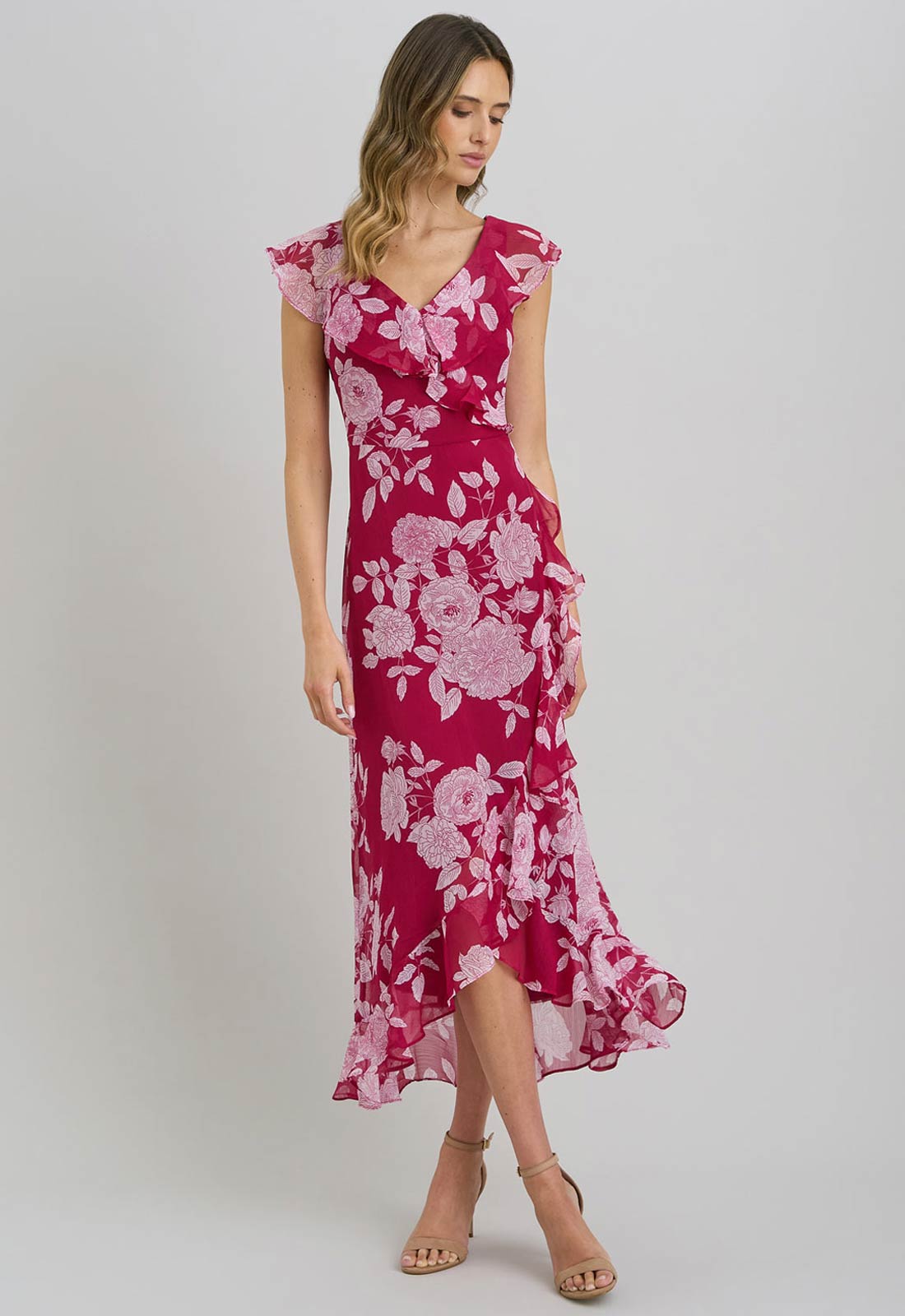 Woman wearing a pink floral dress on a white background