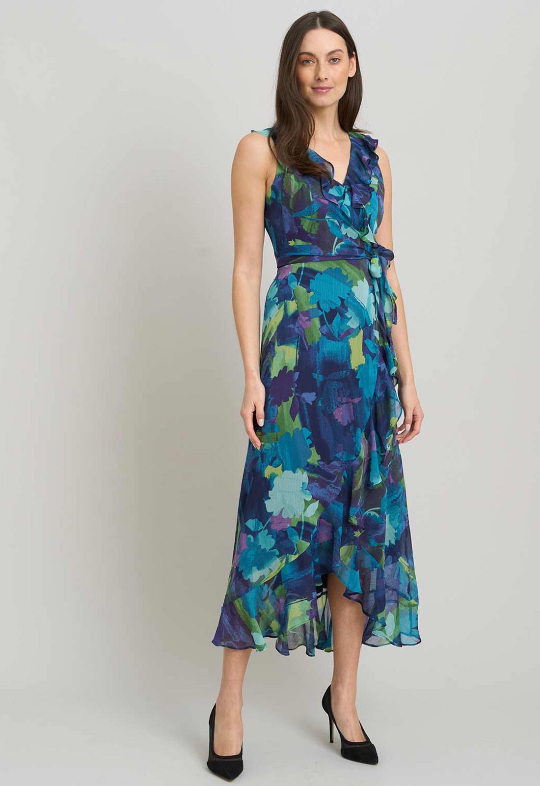 Woman wearing a blue floral dress on a plain background