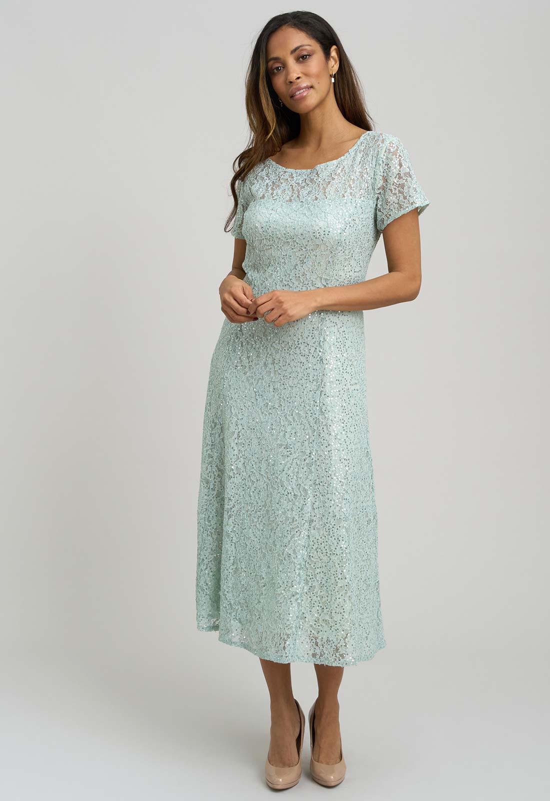 Woman wearing a light blue lace dress on a white background