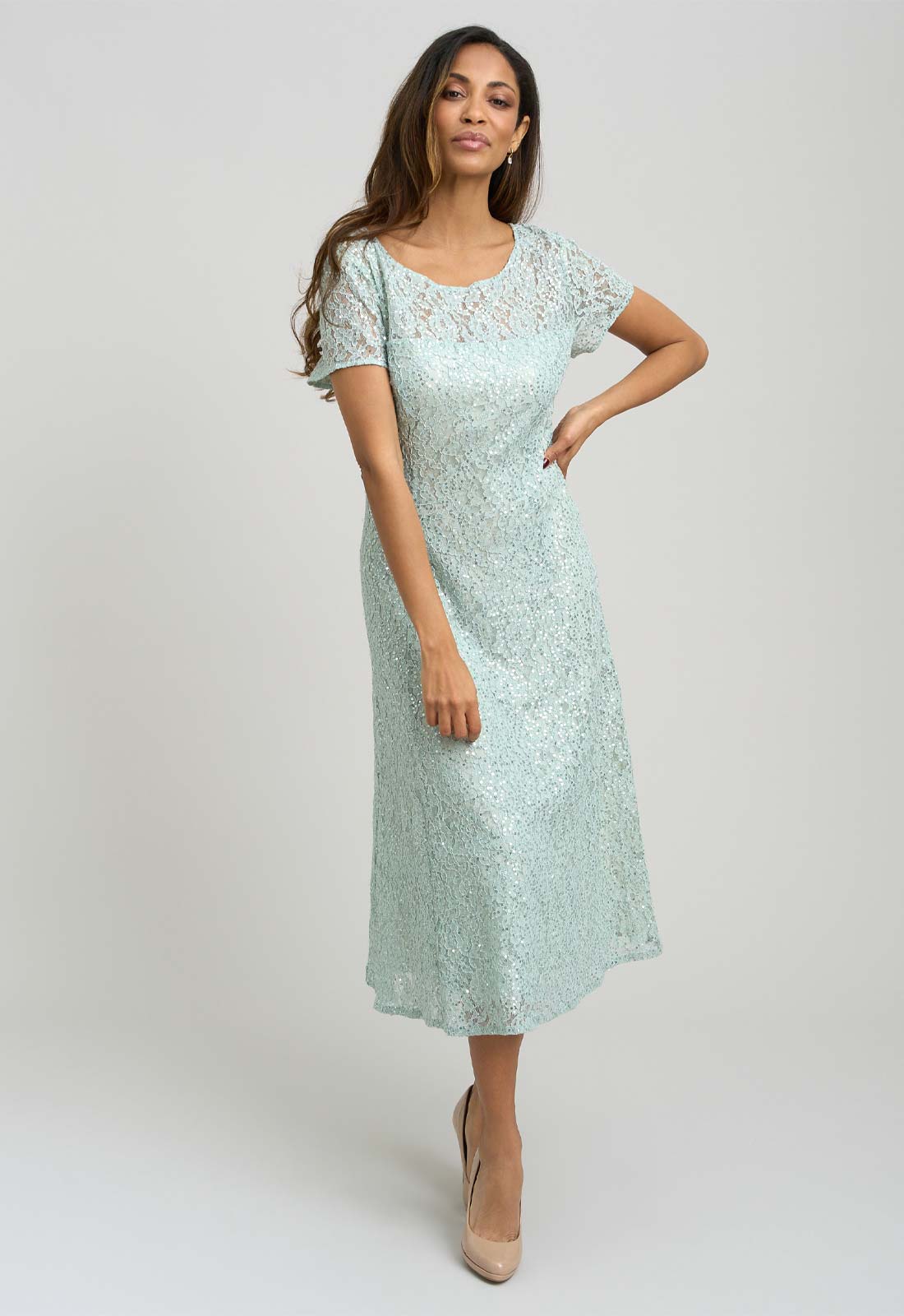 Woman wearing a light blue lace dress on a white background