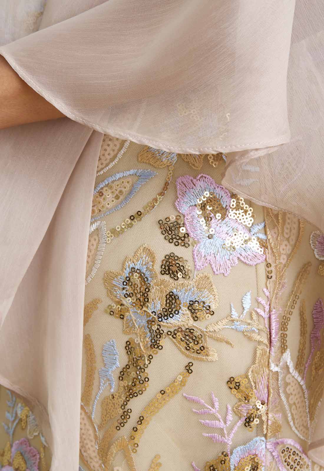 Close-up of a beige garment with floral embroidery and sequins.