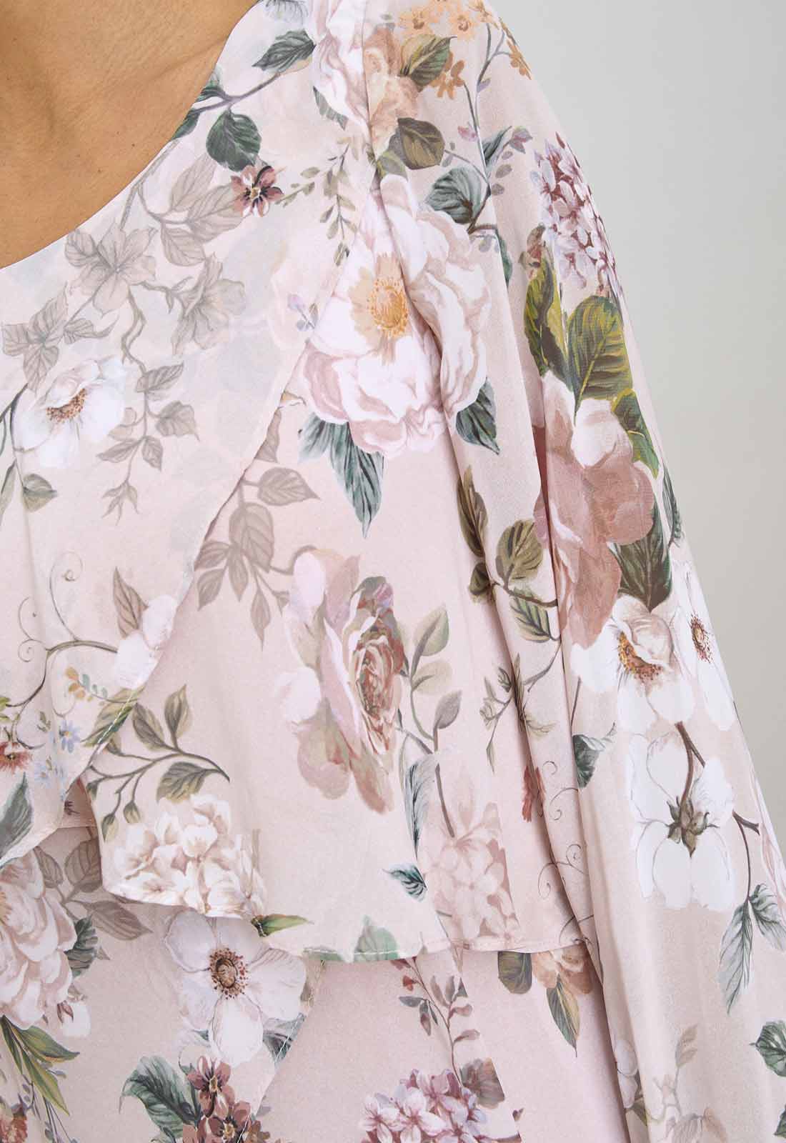 Floral patterned fabric with pink and green colors on a plain background