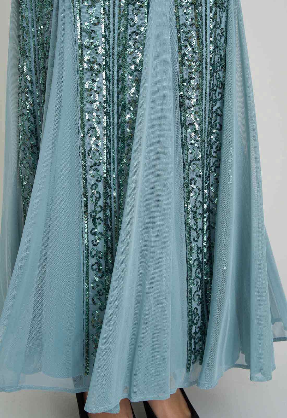 Light blue fabric with sequin detailing against a white background