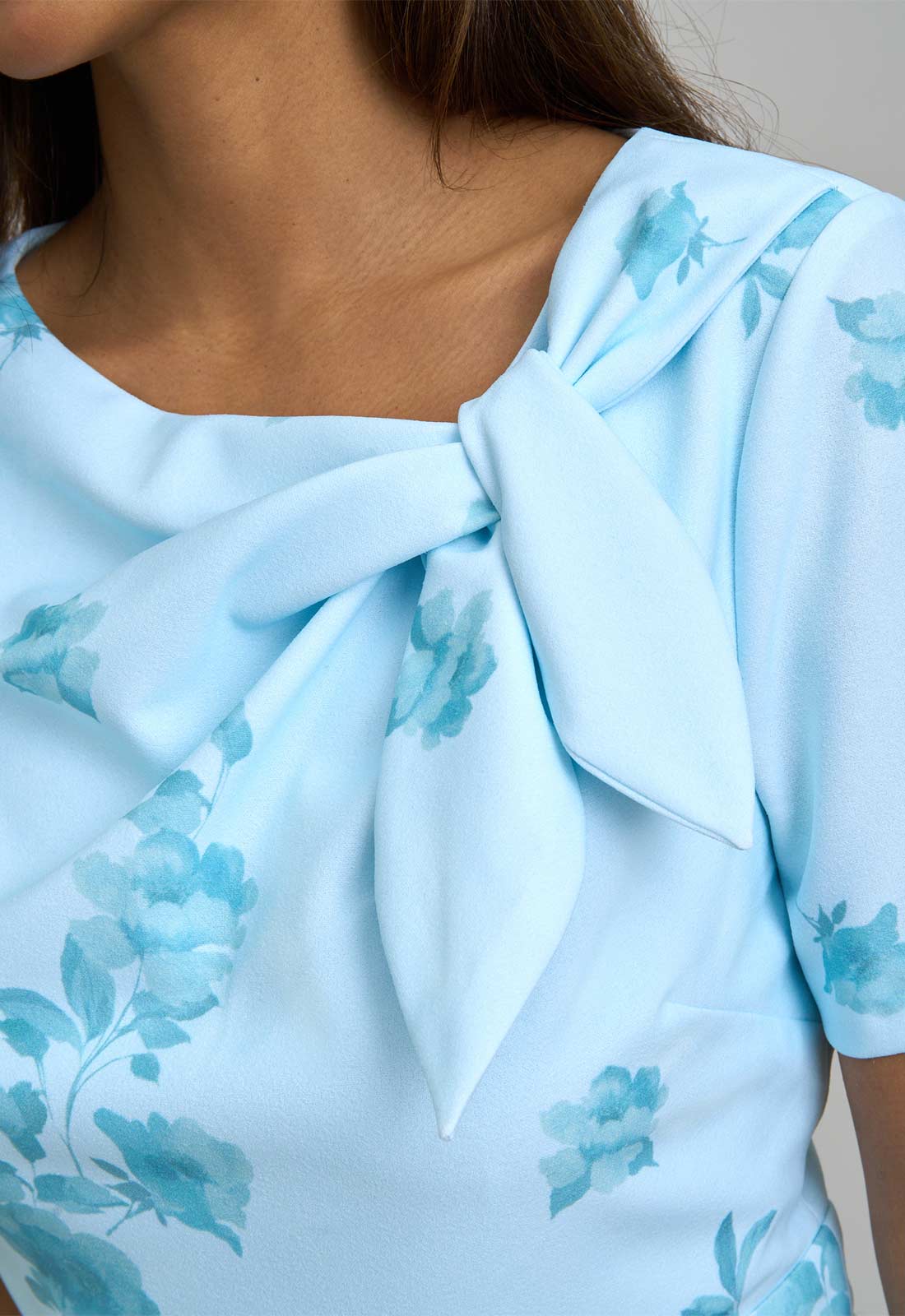Light blue blouse with floral pattern and bow detail