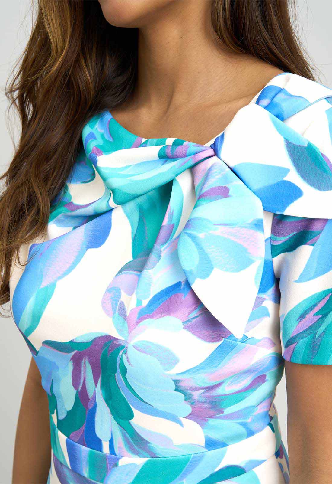 Close-up of a colorful floral dress with a white background