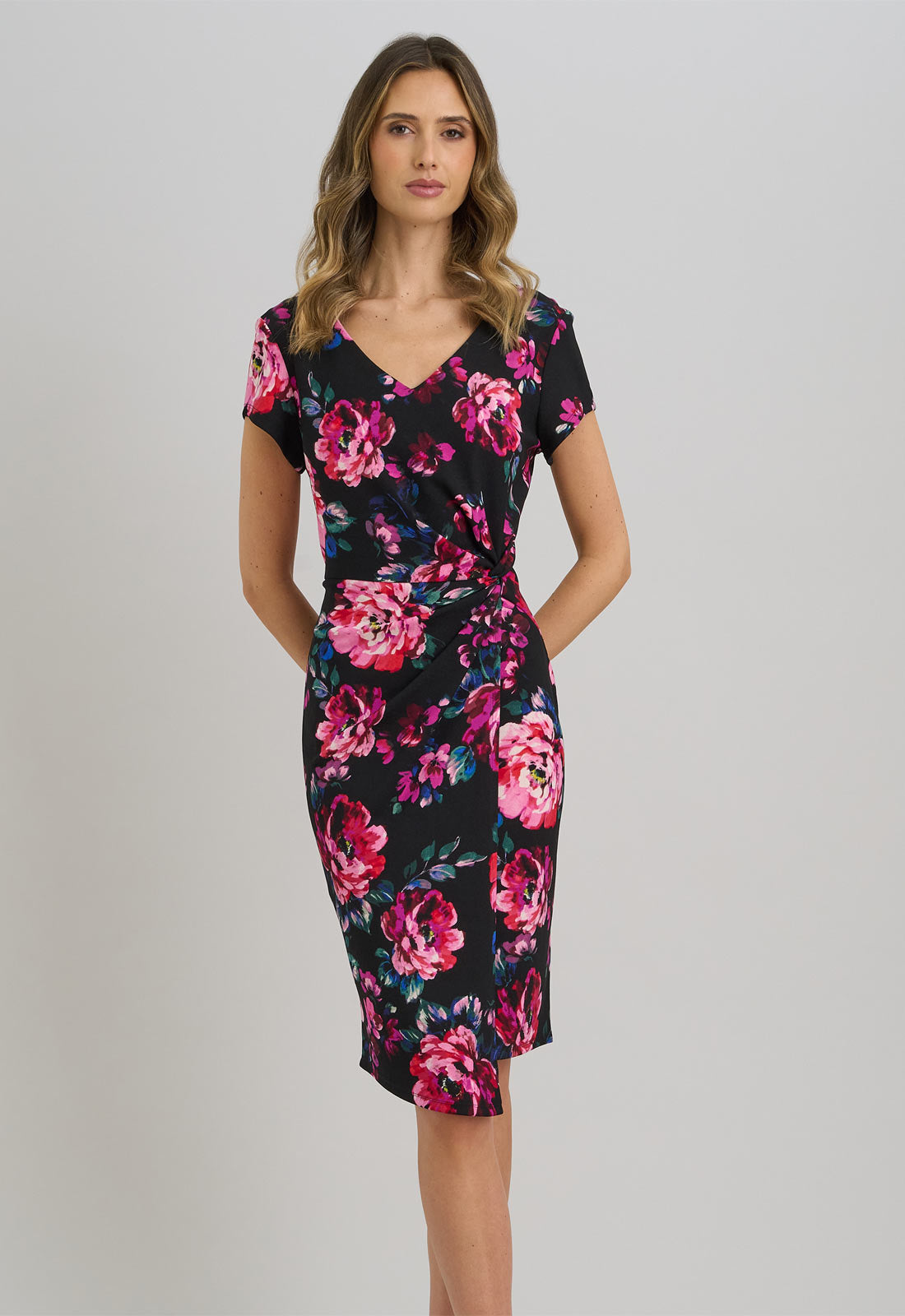 Woman wearing a floral dress on a plain background