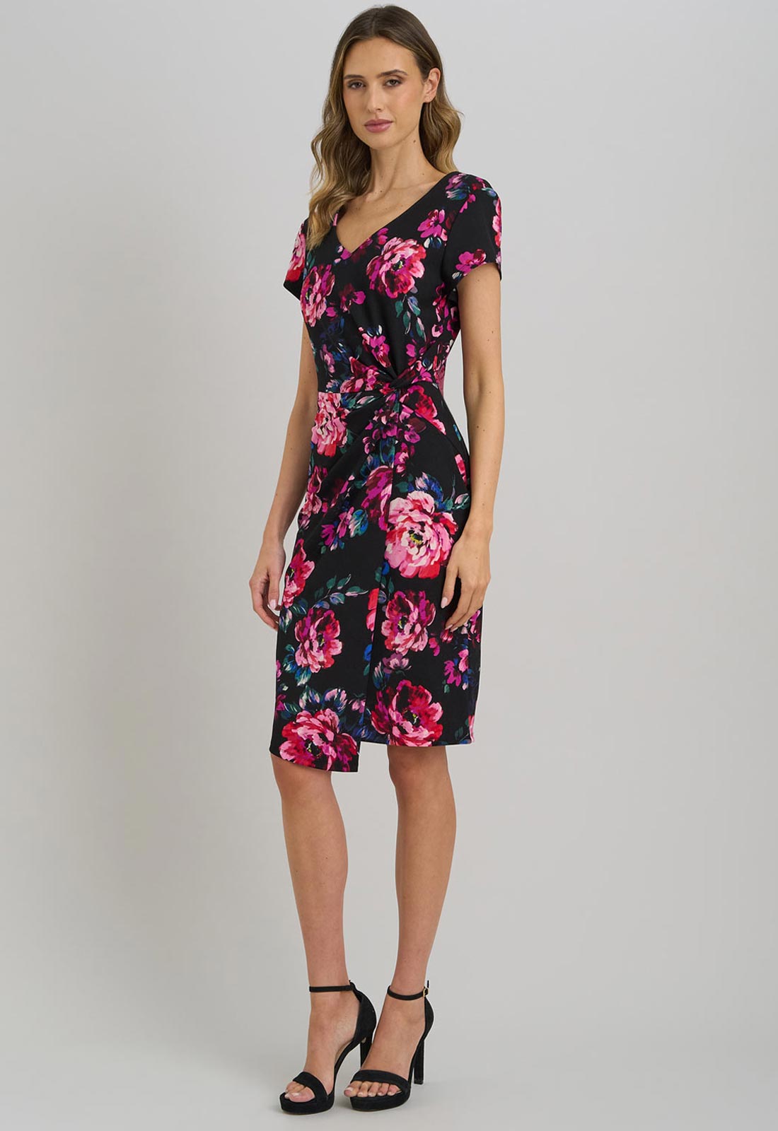 Woman wearing a floral dress on a plain background
