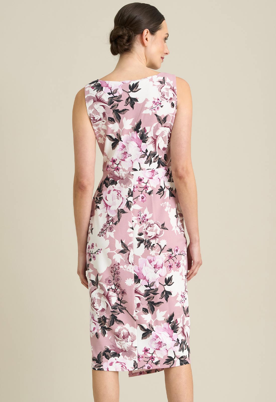 Woman wearing a floral dress with a beige background