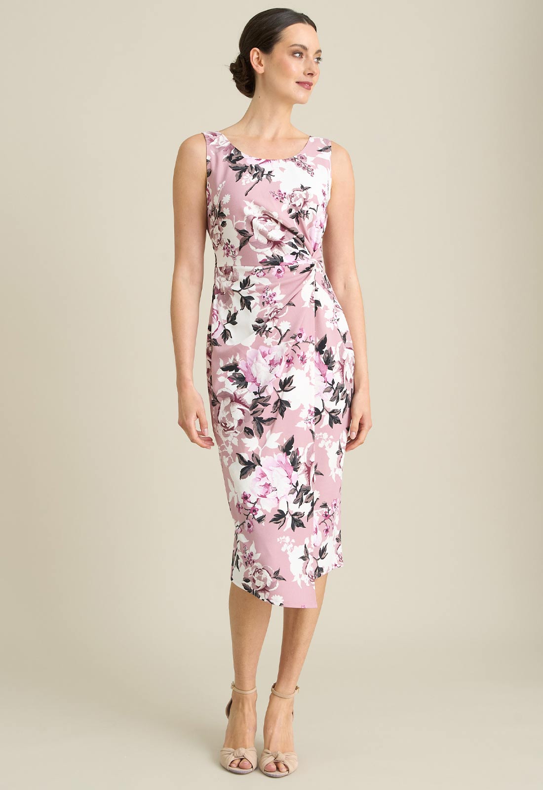 Woman wearing a floral dress on a beige background