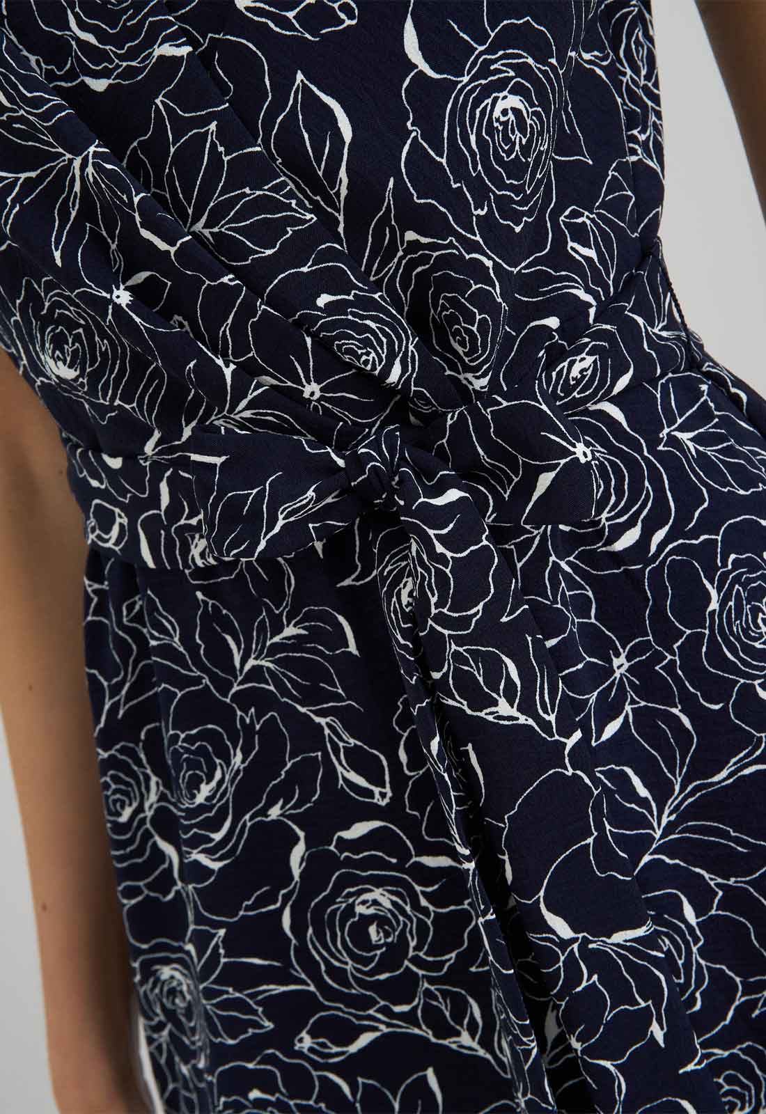 Navy blue dress with white floral pattern on a plain background