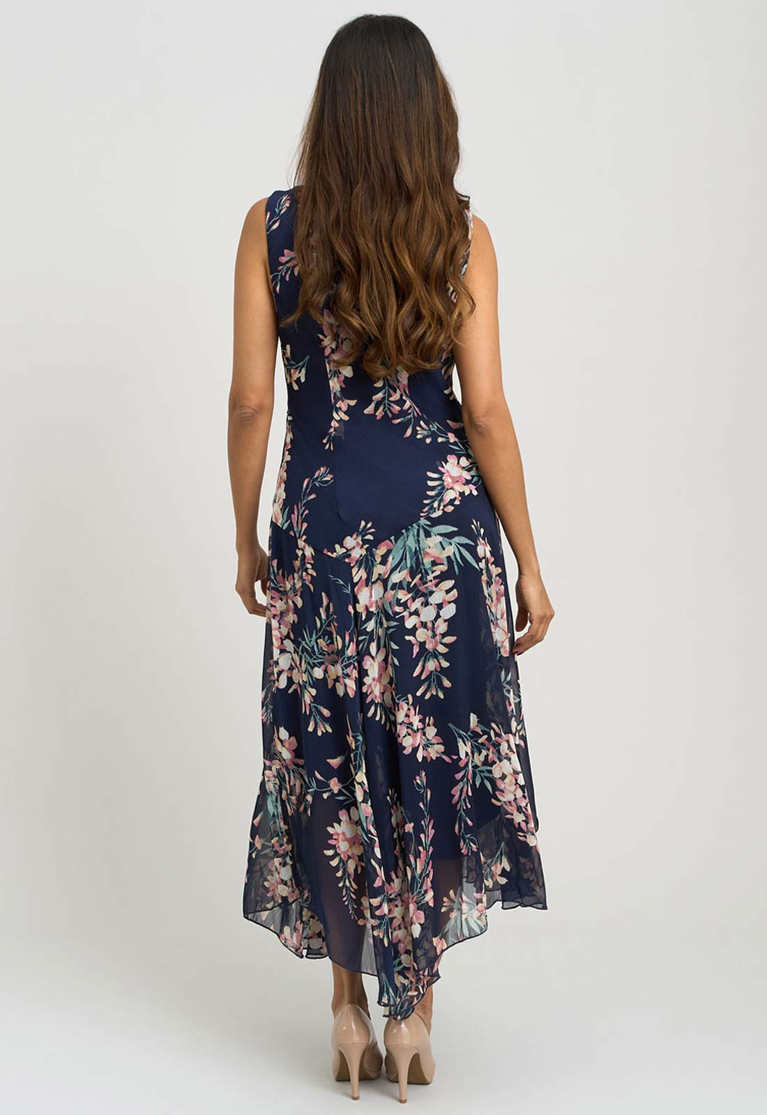 Woman wearing a navy floral dress on a white background