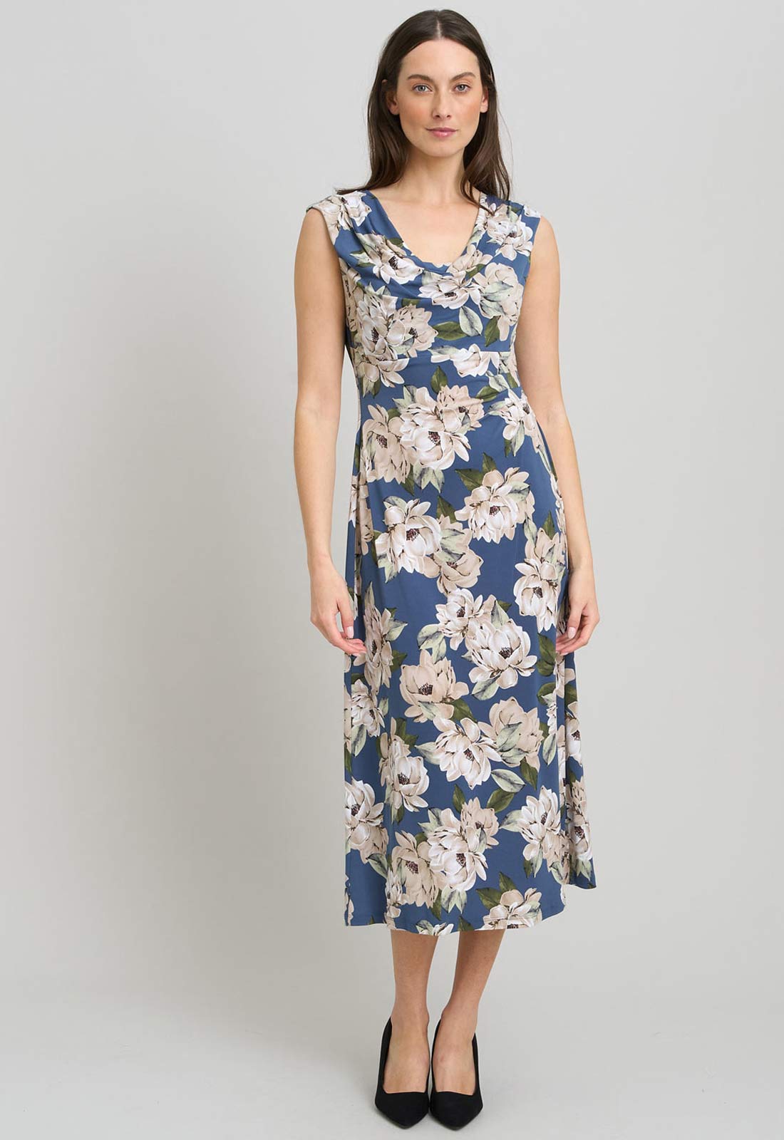 Woman wearing a floral dress on a gray background
