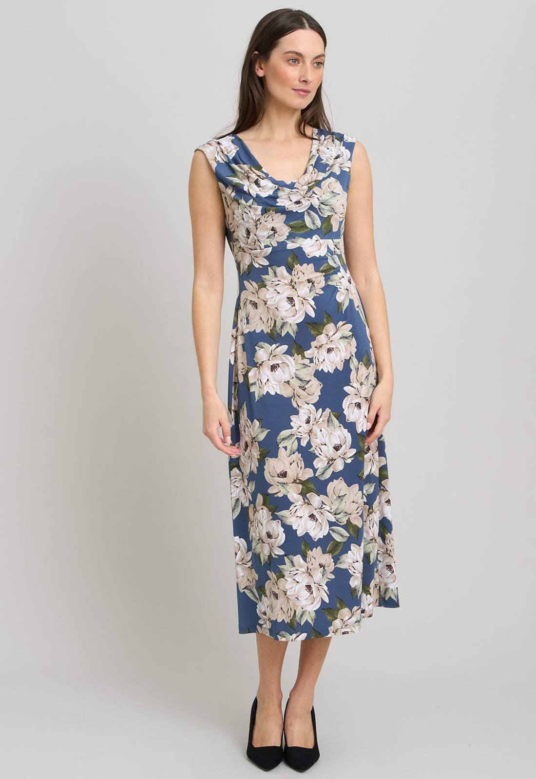 Woman wearing a blue floral dress on a gray background