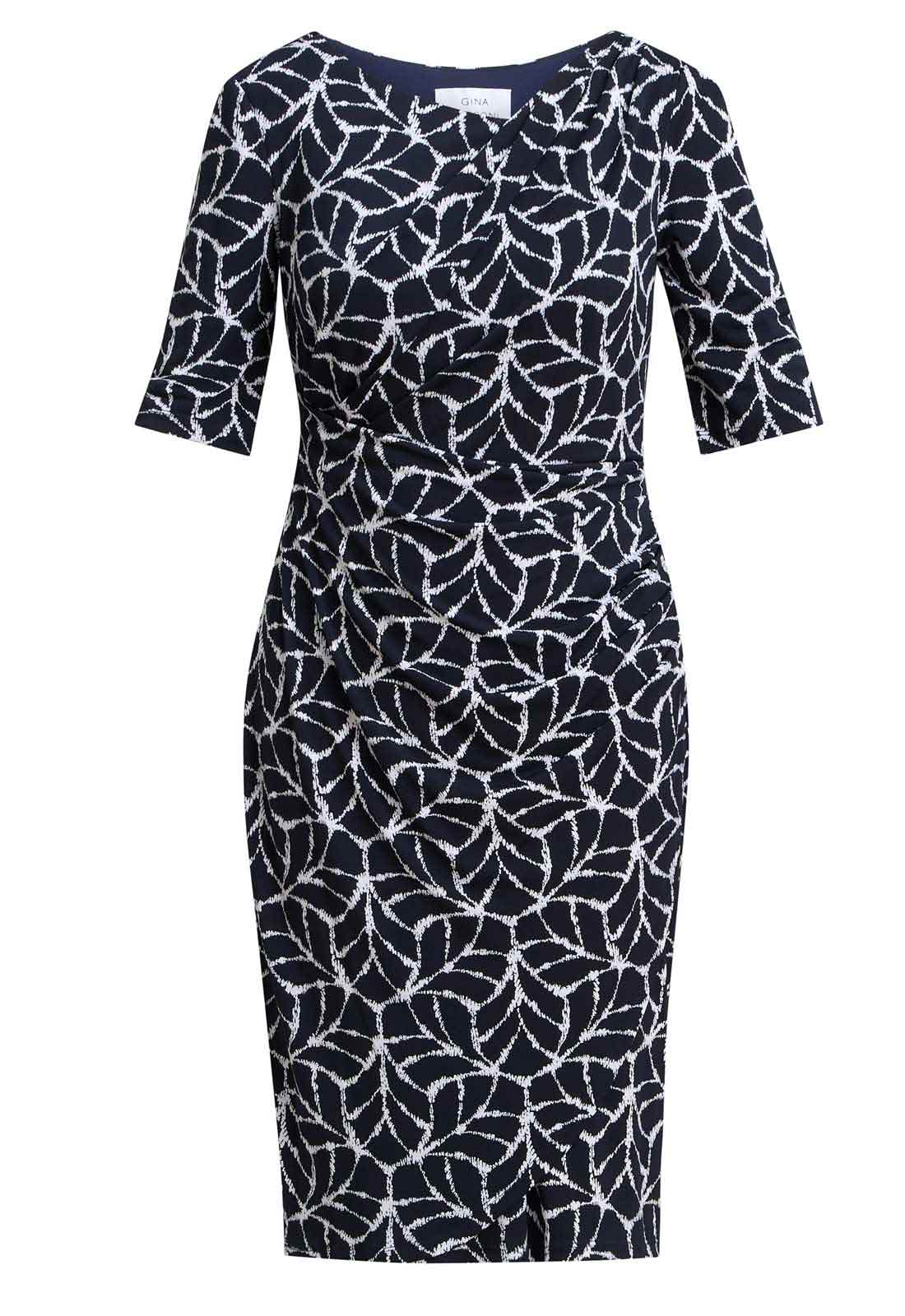 Navy dress with white leaf pattern on a white background
