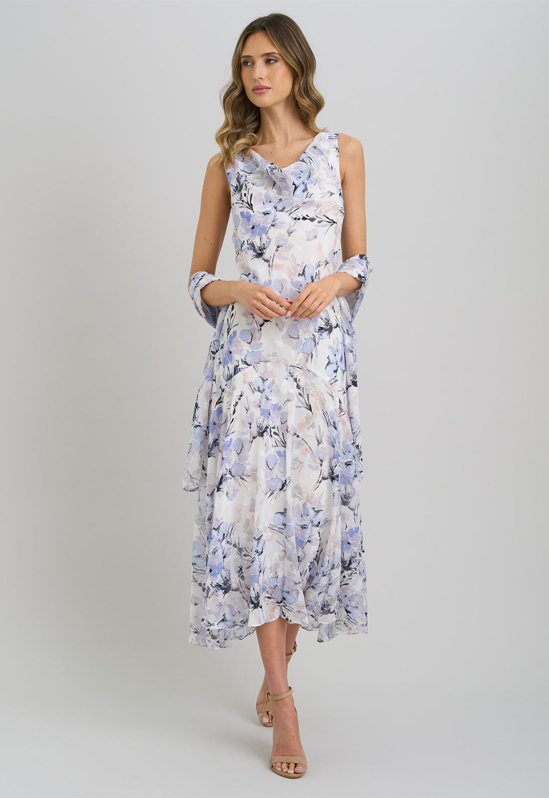 Woman wearing a floral dress on a plain background