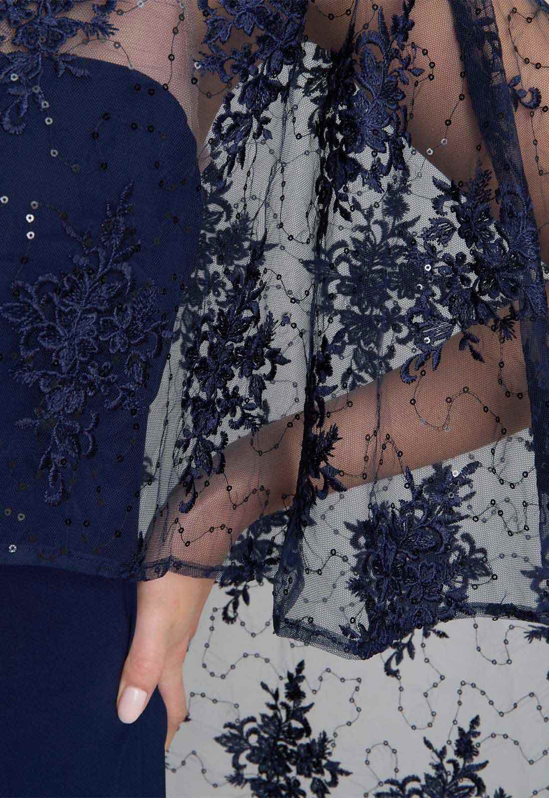 Navy blue and white lace garment with floral patterns