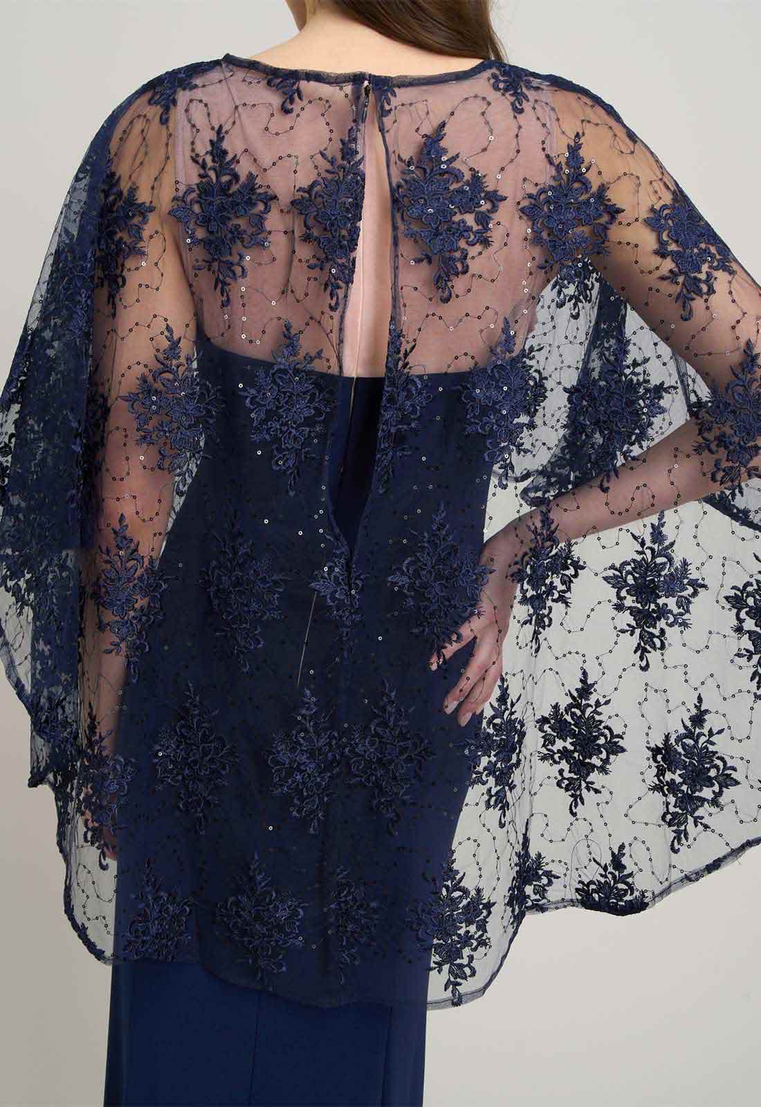 Navy blue lace dress with sheer overlay on a neutral background