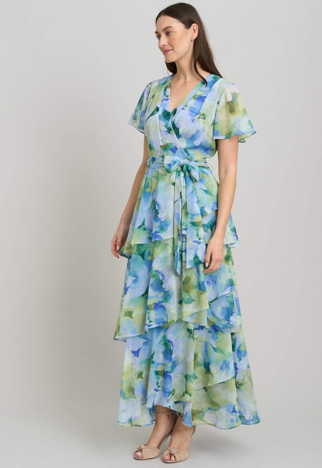 Woman wearing a floral dress with a plain background