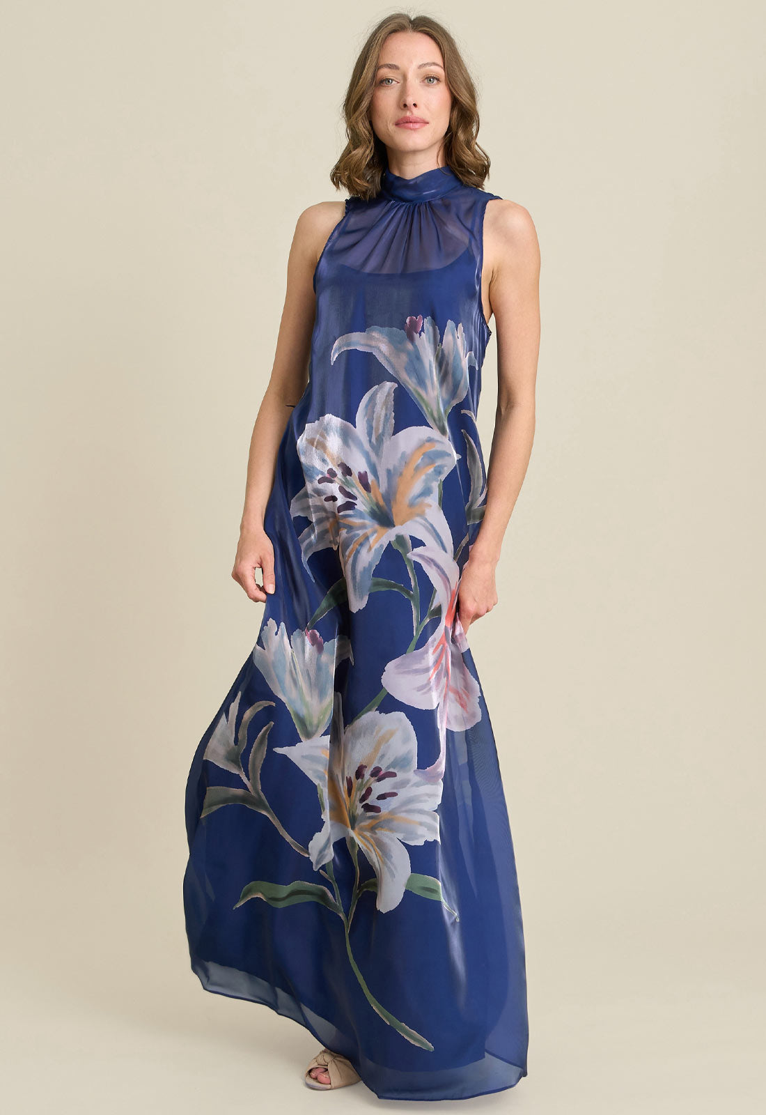Woman wearing a blue floral dress on a beige background