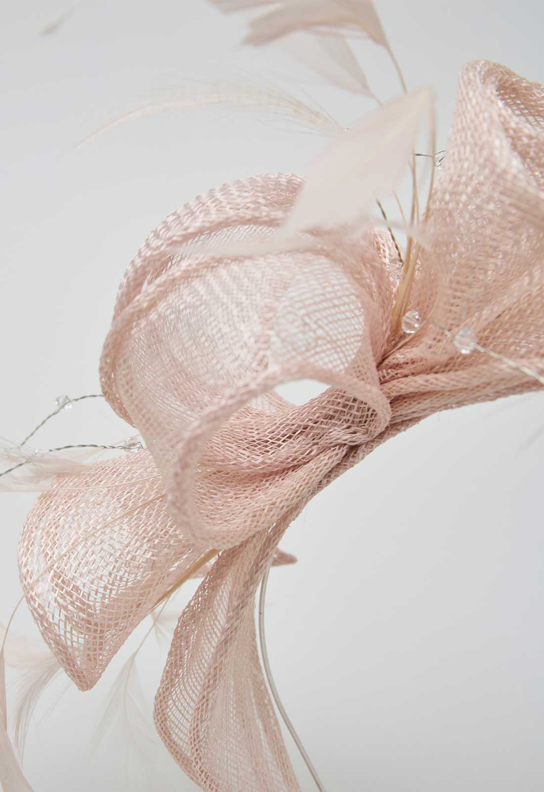 Pink mesh bow with dried flowers on a light background