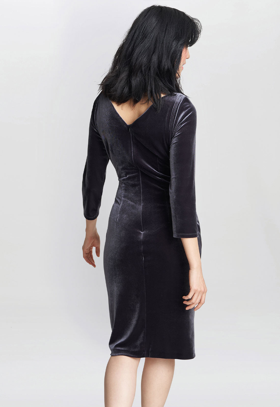 Black velvet dress worn by a person on a white background