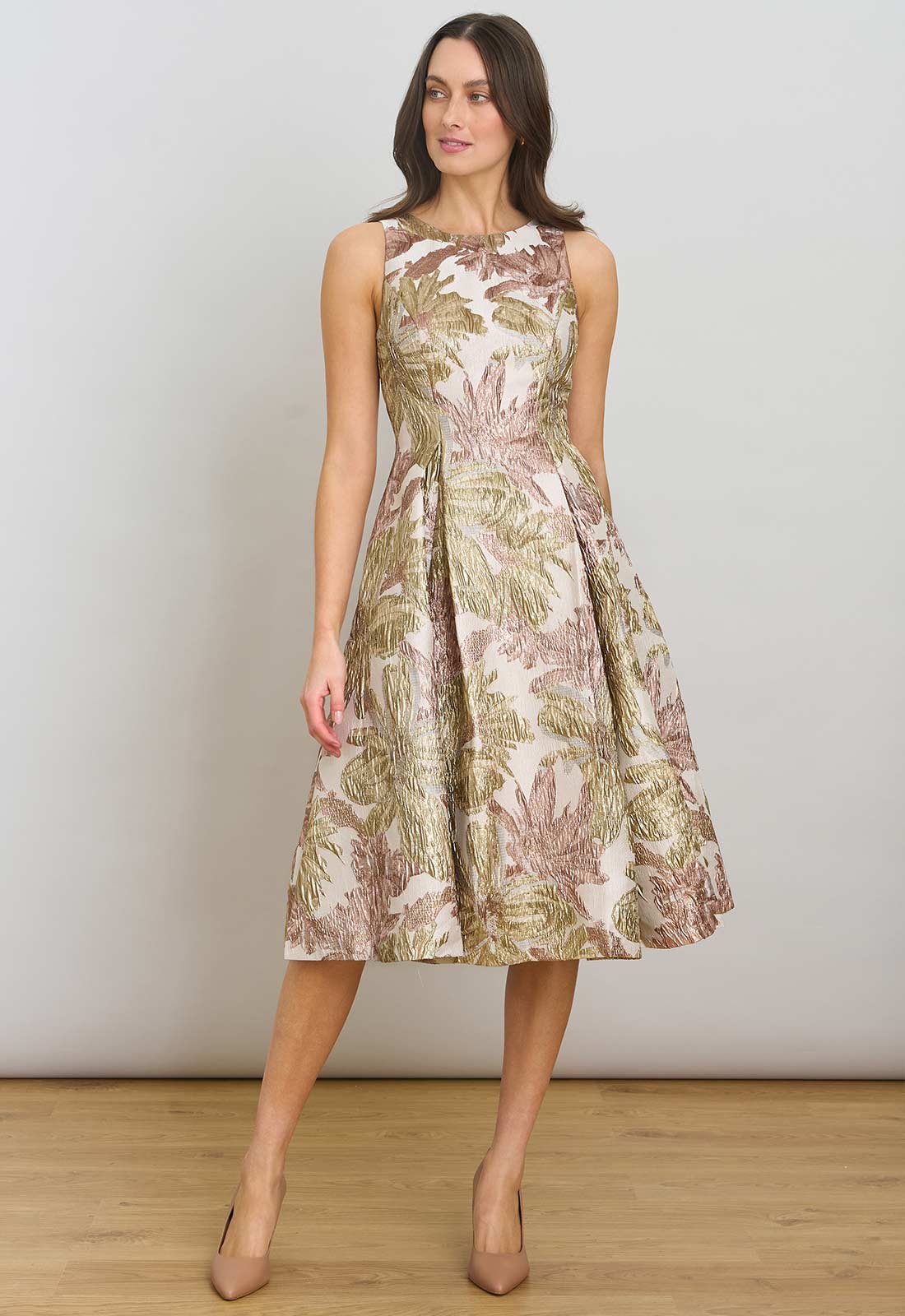 Woman wearing a floral dress against a plain background