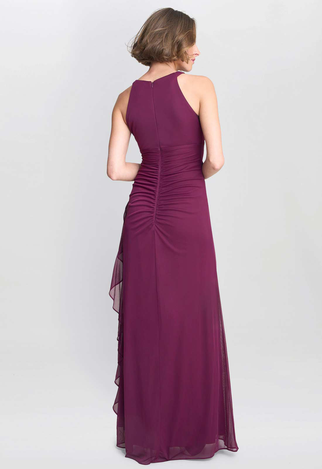 Woman wearing a long purple dress on a white background